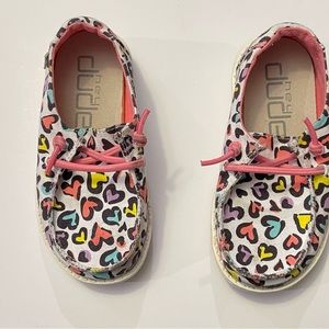 White Hey Dude slip ons with colorful hearts